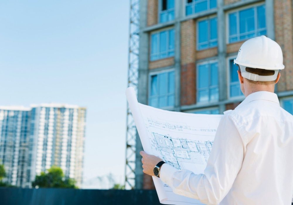 back-view-man-holding-building-plans (1)