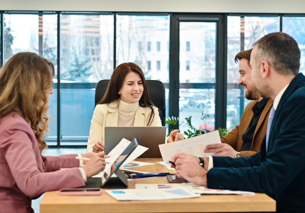 Business meeting in an office, workers discussing business affairs. Gadgets and papers on the table